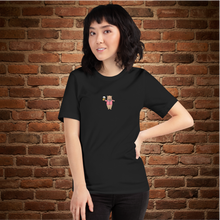 Load image into Gallery viewer, Woman wearing Rudy’s Bar &amp; Grill Valentine’s Day NYC Edition T-shirt, front view – Baron Von Swine graphic on black shirt, brick wall background