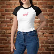 Load image into Gallery viewer, Woman wearing Rudy’s Bar &amp; Grill women’s micro rib raglan baby tee in white with black sleeves and Rudy’s script logo, standing in front of a brick wall