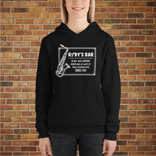 Load image into Gallery viewer, Woman wearing a black Rudy’s Bar &amp; Grill Jazz Saxophone Unisex Hoodie, standing in front of a brick wall background