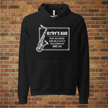 Load image into Gallery viewer, Black Rudy’s Bar &amp; Grill Jazz Saxophone Unisex Hoodie displayed upright in front of a brick wall background