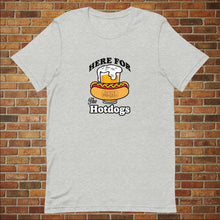 Load image into Gallery viewer, Athletic heather &quot;Here for the Hot Dogs&quot; T-shirt from Rudy’s Bar &amp; Grill, displayed flat in front of a brick wall background