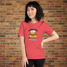 Load image into Gallery viewer, Person wearing a heather red &quot;Here for the Hot Dogs&quot; T-shirt from Rudy’s Bar &amp; Grill in front of a brick wall background