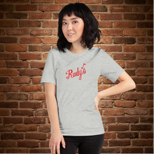 Load image into Gallery viewer, Vintage Rudy&#39;s Bar &amp; Grill unisex t-shirt in athletic heather on model posing against brick wall