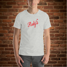 Load image into Gallery viewer, Vintage Rudy&#39;s Bar &amp; Grill unisex t-shirt in athletic heather on model against brick wall