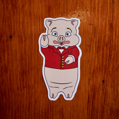 Classic Rudy’s pig sticker bar logo decal on wood background in Hell’s Kitchen NYC