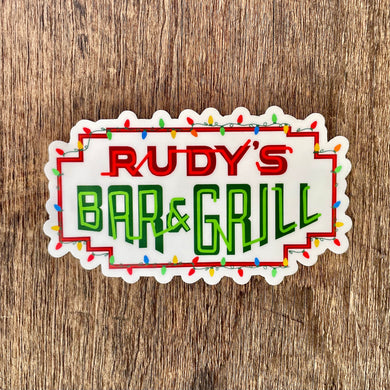 Rudy’s Bar & Grill holiday logo sticker with Christmas lights displayed on rustic wood background