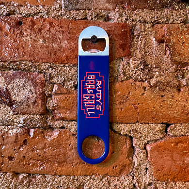 udy’s Bar & Grill neon sign bartender bottle opener hanging on a brick wall