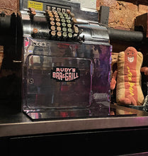Load image into Gallery viewer, Rudy’s Bar &amp; Grill neon sign magnet displayed on vintage cash register in NYC dive bar