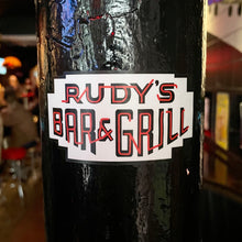 Load image into Gallery viewer, Rudy’s Bar &amp; Grill neon sign logo sticker on black pole inside Hell’s Kitchen bar